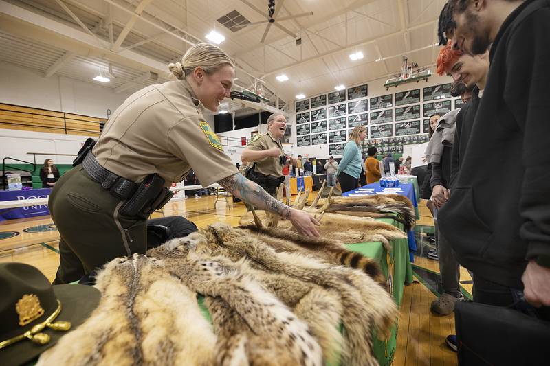 Conservation officers Brianna Phillips (left) and Jamie Posateri quiz students on animal pelts put on display at Rock Falls High School Thursday, March 6, 2025. The school hosted their 10th annual college and career fair, where over 50 schools, businesses, military and support systems set up booths for high school and junior high students to learn about after school options.
