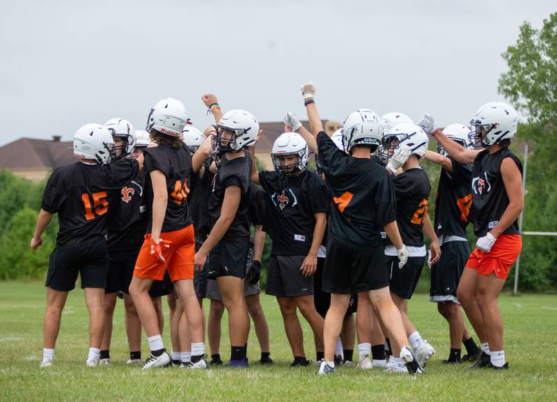 The team St. Charles East football team breaks a huddle during practice at St. Charles East on Monday, Aug. 8, 2022.