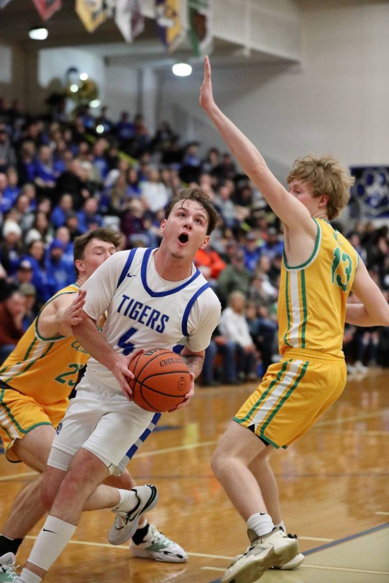 Princeton's Korte Lawson splits U-High defenders Ty Blake (23) and Mason Frank (13)  Saturday night at Prouty Gym.