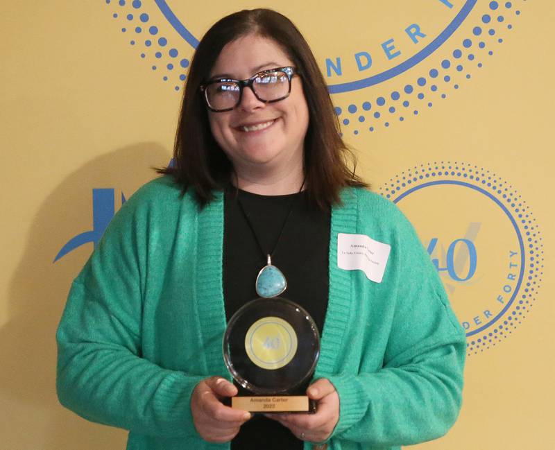 Amanda Carter poses for a photo with her award during the 40 Under Forty awards banquet on Thursday, March 21, 2024 at Westclox in Peru.