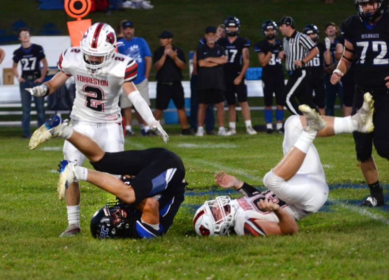 Eastland-Pearl City's Draven Zier (22) hangs on to the ball after colliding with Forreston's Dane Setterstrom (20) and Coehen Kirchner (2) on Friday, Sept. 20, 2024 in a NUIC Conference game in Pearl City.