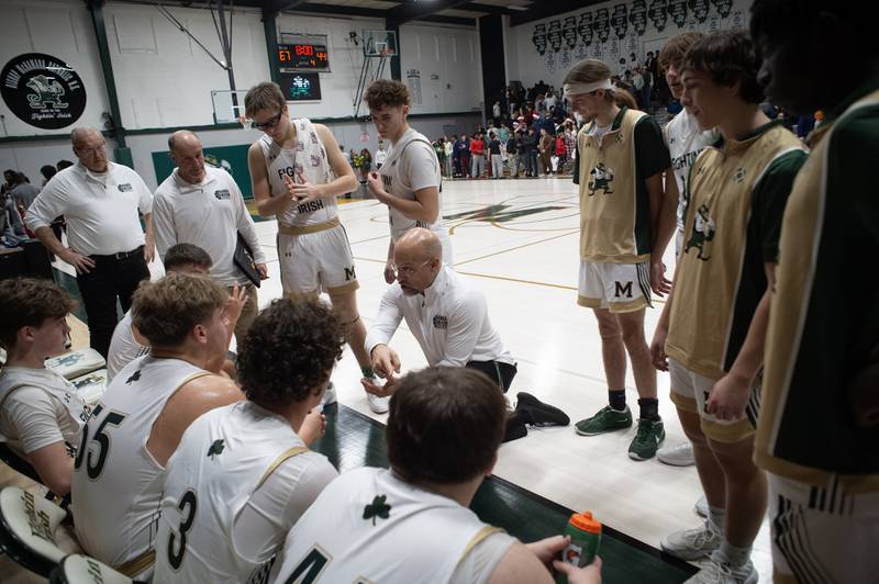 Bishop McNamara's head coach Adrian Provost, center, talks with his team between quarters in a game against Chicago Bulls Prep on Friday, December 19, 2025.
