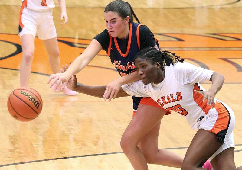 Naperville North's Ava Podkasik and DeKalb’s Kezaria Mitchell go after a loose ball Monday, Jan. 22, 2024, during their game at DeKalb High School.
