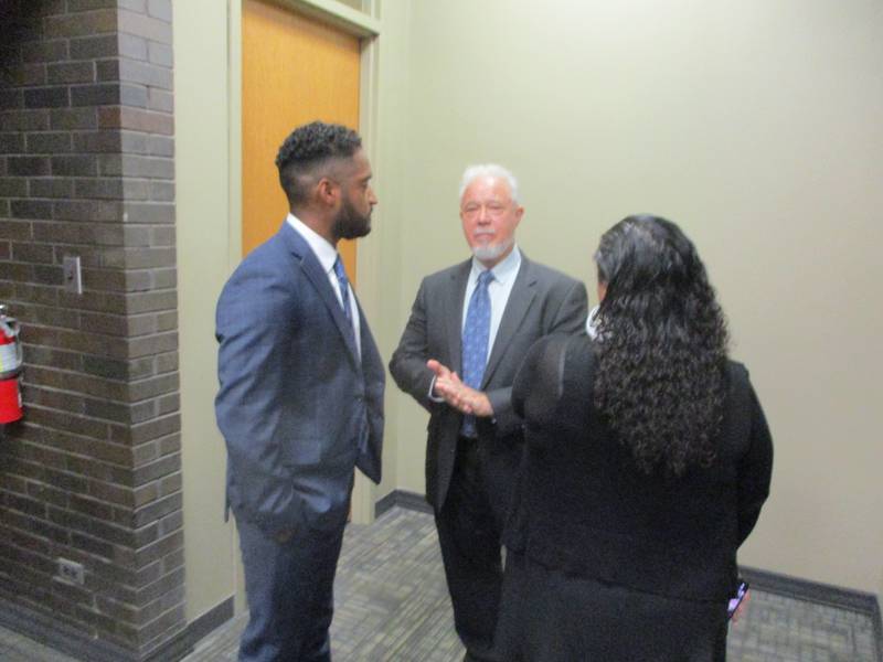 Alfonso Sanchez (left) consults with his attorney Steven Calcaterra (center) after the Joliet Board of Fire and Police Commissioners approved Sanchez's termination from the Joliet Police Department. Aug. 25, 2025