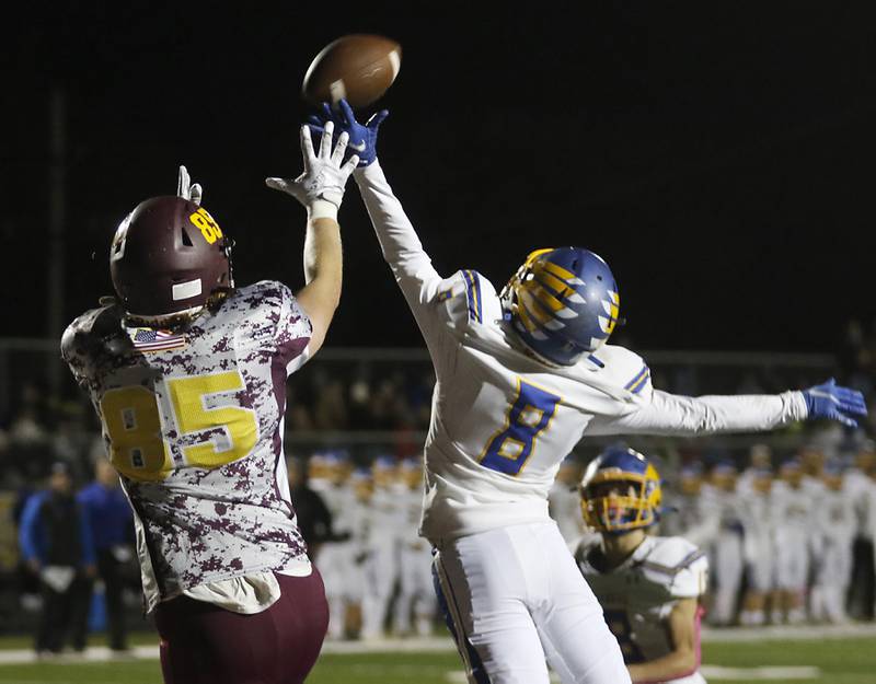 Johnsburg's Damin Green, right, tips the ball intended for Richmond-Burton's Luke Bresnahan, left, during a Kishwaukee River Conference football game Friday, Oct. 7, 2022, between Richmond-Burton and Johnsburg at Richmond-Burton Community High School in Richmond.