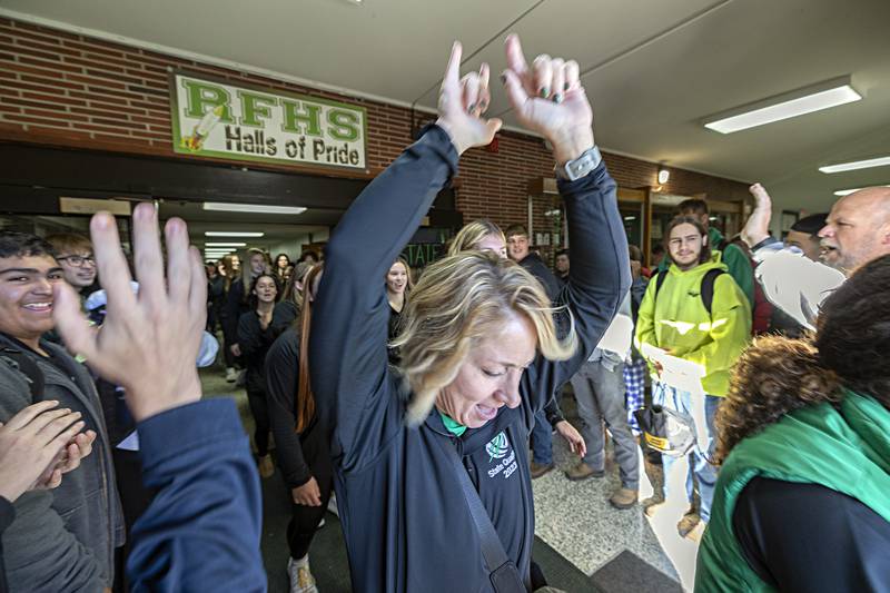 Rock Falls volleyball head coach Sheila Pillars celebrates with the school as she leads her team through the hallway Thursday, Nov. 9, 2023. The team was given a rousing sendoff as they make their way to the state tournament. The team will play Breese Friday at 1:30 in Normal.
