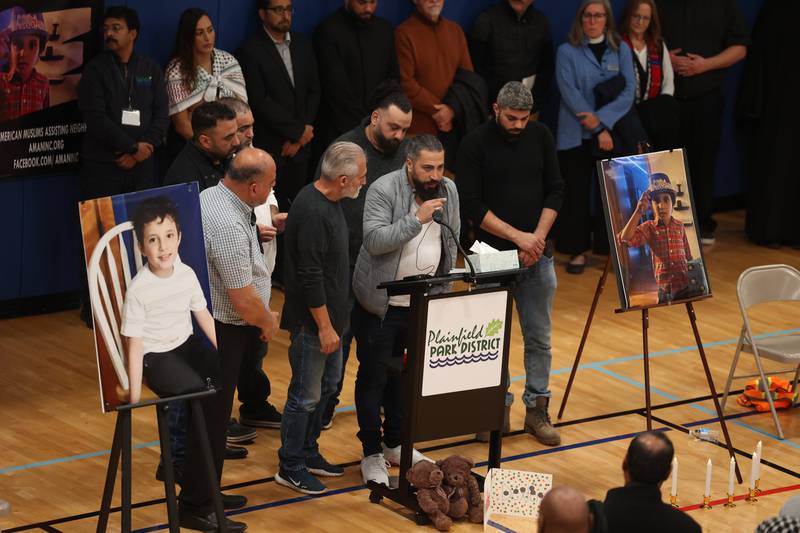 Oday Al-Fayoume is surround by family as he shares a few words at a vigil for his son Wadea Al-Fayoume at Prairie Activity & Recreation Center on Tuesday, Oct. 17, 2023 in Plainfield.