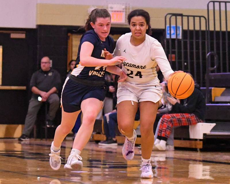 Neuqua Valley's Nalia Clifford, left, battles for the ball against Sycamore's Monroe McGhee during the first quarter on Wednesday Nov. 29, 2023, held at Sycamore High School.