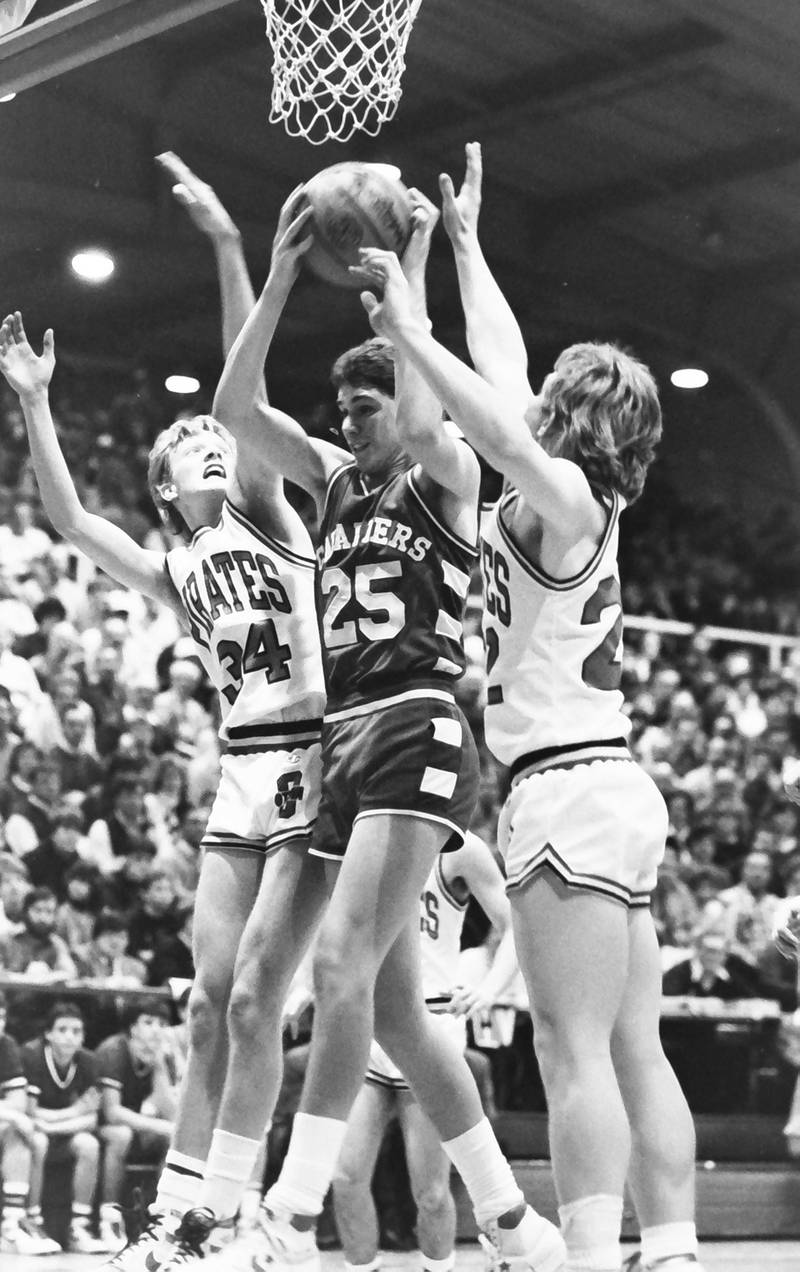L-P's Mark Anglavar grabs a rebound over Ottawa's Dave Yell and during the Regional title game on Saturday, Feb. 28, 1986 at La Salle-Peru Township High School.
