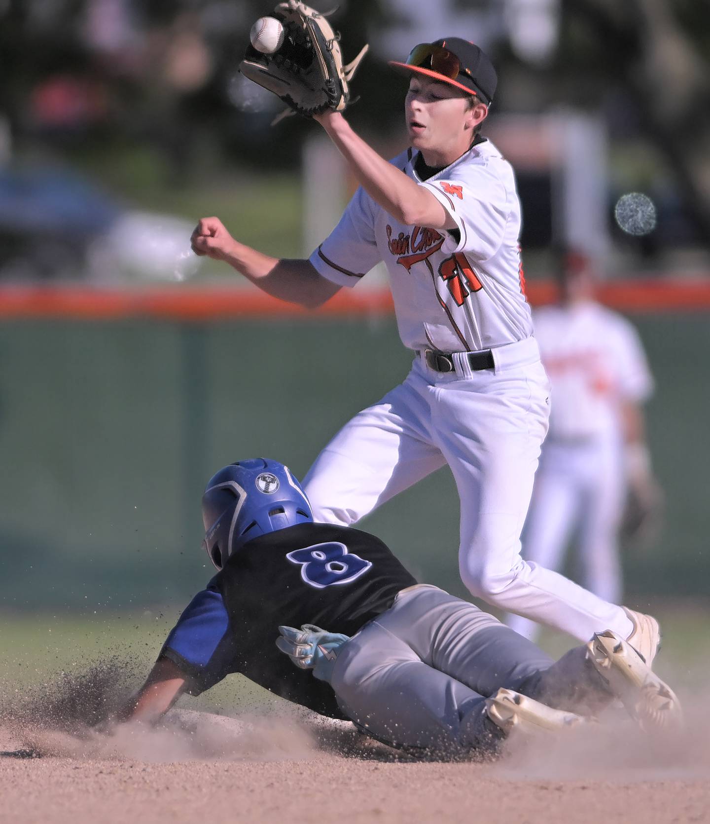 St. Charles East’s Sean Groselak catches a throw before tagging out Geneva’s Nick Lozano on a steal attempt in a baseball game in St. Charles on Wednesday, May 20, 2026.