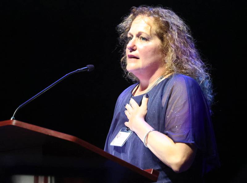 Athena Award recipient Jennifer Yochem reacts as she takes the stage for her acceptance speech during the Athena and Women of Accomplishment awards reception hosted by the DeKalb Chamber of Commerce Thursday, Oct. 10, 2024, at the Egyptian Theatre.