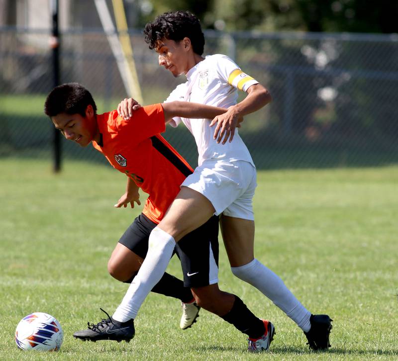 Crystal Lake Central’s Angel Perez, left, battles Harvard’s Jesus Aquino in varsity boys soccer at Crystal Lake Central High School in Crystal Lake on Saturday, Sept. 6, 2025.