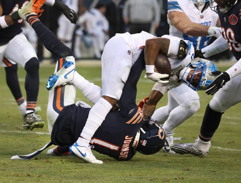 Chicago Bears cornerback Jaylon Johnson brings down Detroit Lions running back Jahmyr Gibbs during their game Sunday, Jan. 4, 2026, at Soldier Field in Chicago.