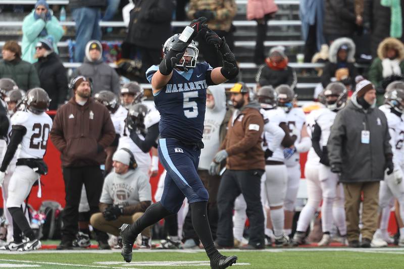 Nazareth’s Gabe Kaminski points to his ring finger indication a championship ring after a defensive stop that sealed a win over Joliet Catholic in the Class 5A state championship on Saturday, Nov. 30, 2024 in Normal.