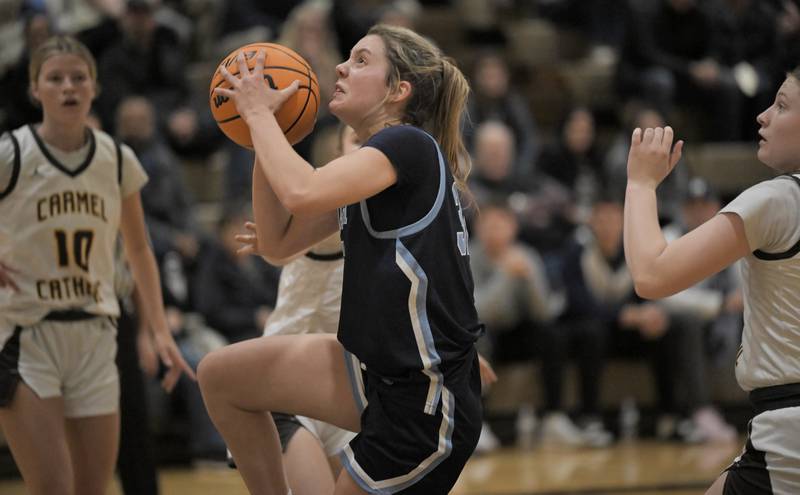 Nazareth’s Stella Sakalas drives into the Carmel defense in a girls basketball game in Mundelein on Wednesday, Jan. 7, 2026.
