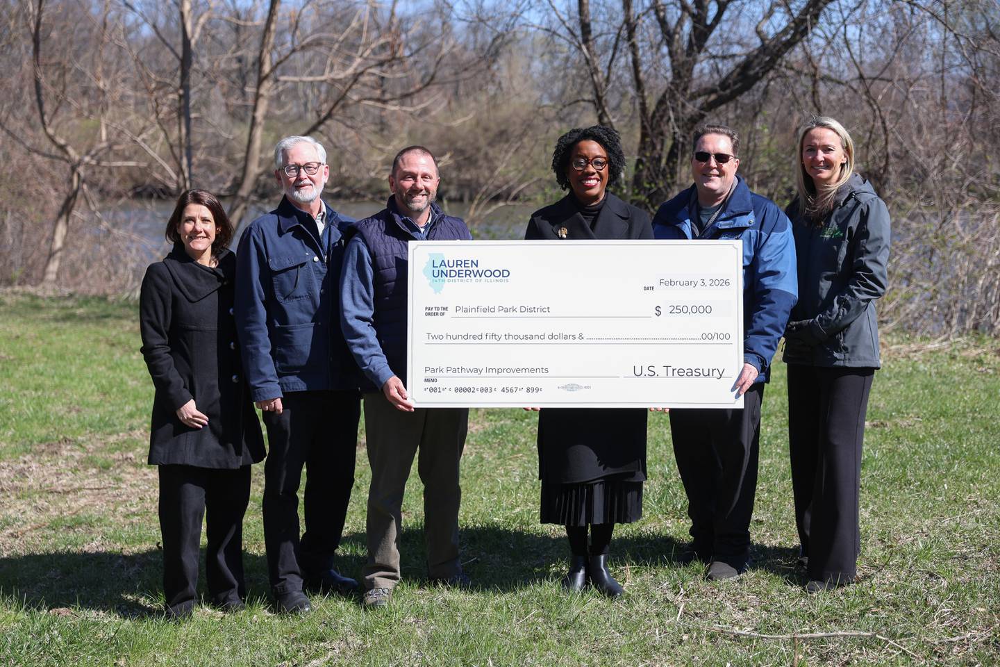 U.S. Rep. Lauren Underwood, D-Naperville, poses with members of Plainfield Park District after presenting a check for $250,000 for the Bentley Road pathway connection on Tuesday, April 7, 2026 in Plainfield. The Plainfield Park District is in the very early stages creating a four mile pathway, a vital link between Riverside Parkway, Sunset Park, and Hammel Woods trails along the DuPage River corridor.