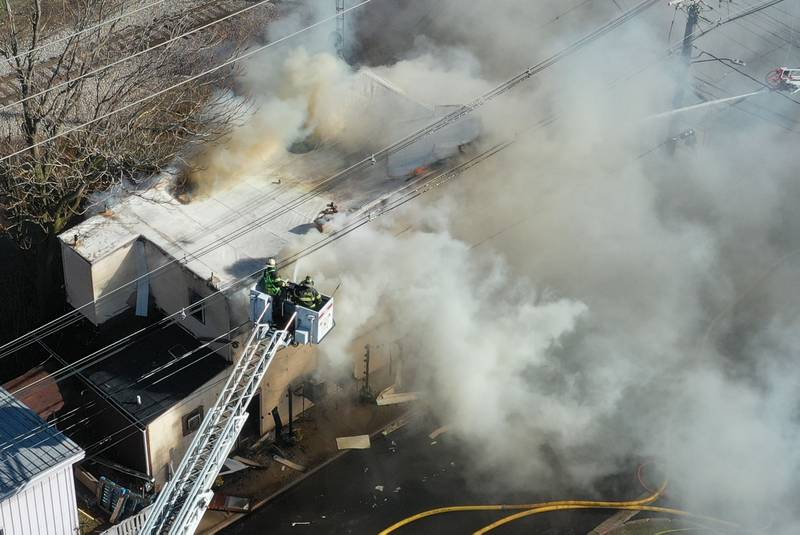 Peru firefighters use their aerial fire truck to spray water on top of the former Platform 31 tavern on Monday, March 24, 2025 on Water Street in Peru. The fire was upgraded to a three-alarm summing ire departments from La Salle, Utica, Mendota, Tonica, Ottawa, Ladd, Spring Valley, Lostant, Cedar Point, Troy Grove and Peru responded to the fire.