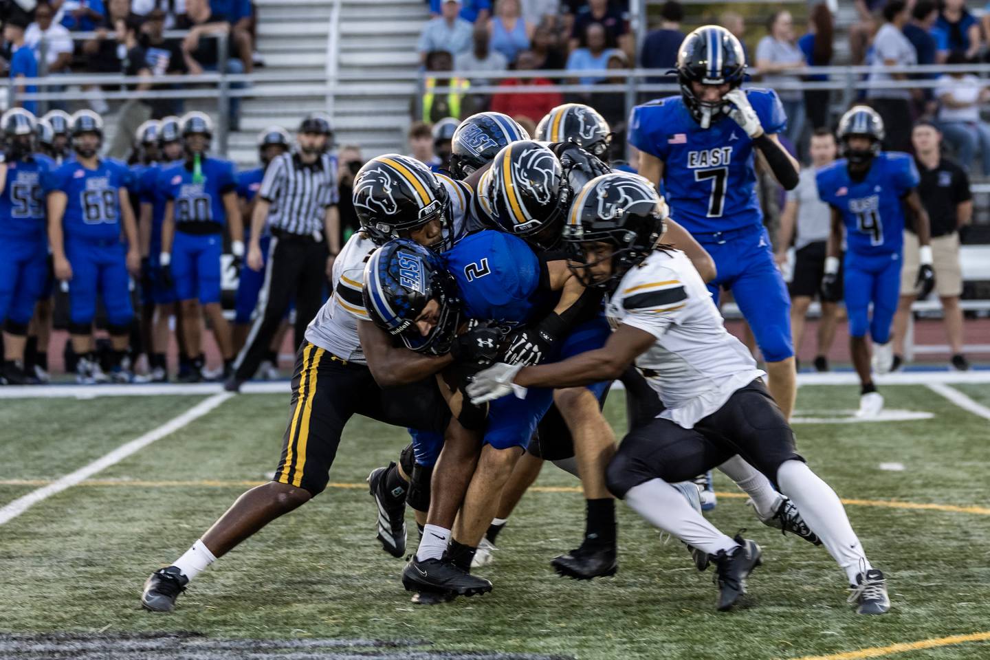 Lincoln-Way East's Brody Gish gets tackled by the Metea Valley defense during a varsity football game at Lincoln-Way East on Oct. 3, 2025.