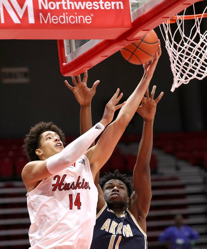 Northern Illinois' Yanic Konan Niederhauser gets to the basket ahead of Akron’s Sammy Hunter during their game Tuesday, Jan. 2, 2024, in the Convocation Center at NIU in DeKalb.