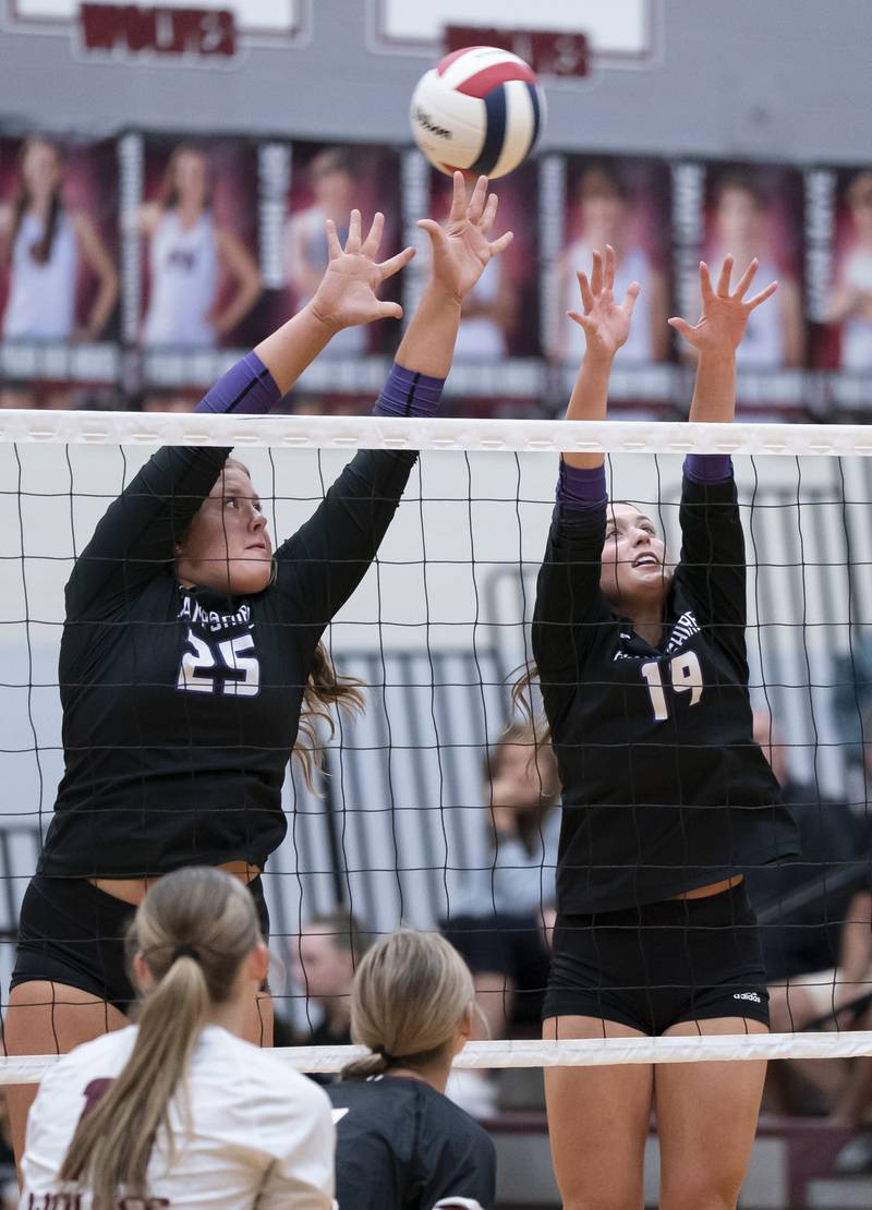 Hampshire's Hailey Homola, left, and Katelynn Petterson jump up for a block at the net during their game against Prairie Ridge on Thursday, October 2, 2025 at Prairie Ridge High School in Crystal Lake. Ryan Rayburn for Shaw Local