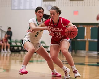 Hinsdale Central's Grace Dolan (32) drives past York's Anna Filosa (2) during basketball game between Hinsdale Central at York. Dec 8, 2023.