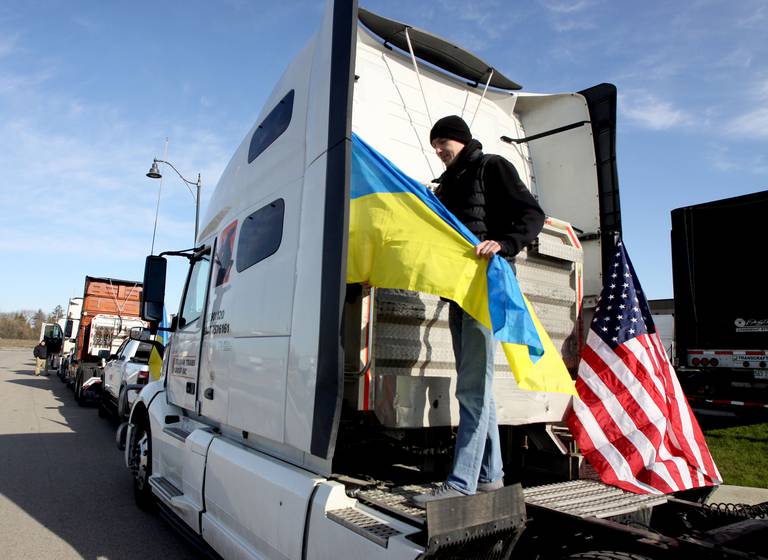 Oleg Mykytin of Addison attaches a flag to his truck as drivers gather Saturday morning in East Dundee to begin the Deblockade Mariupol truck protest rally hosted by Help Ukraine Foundation LTD to bring attention to the blockade of Mariupol.