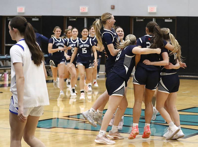 St. Viator celebrates defeating Geneva in the IHSA Class 3A Woodstock North Supersectional girls basketball game on Monday, March 2, 2026, at Woodstock North High School.