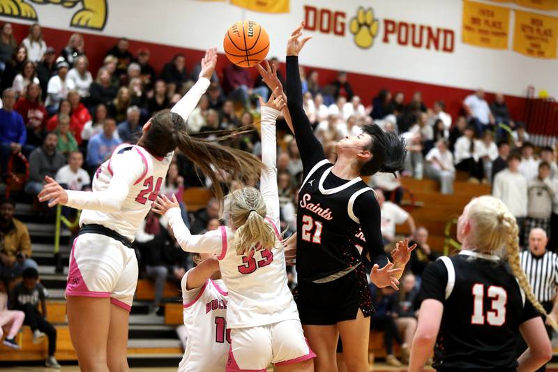 St. Charles East's Sofia O’Sullivan (far right) goes for the rebound during a game against Batavia on Thursday, Feb. 6, 2025 in Batavia.