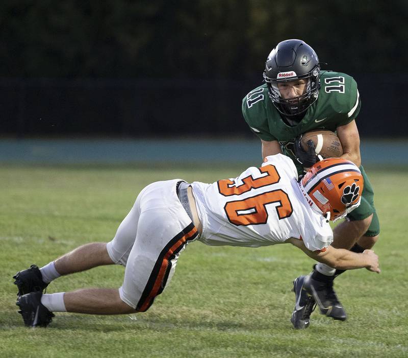 Rock Falls’ Logan Thome is tackled by Byron’s Nathan Wheeler Thursday, August 28, 2025.