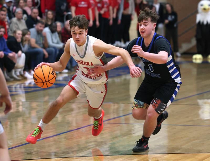 Aurora Christian's Preston Morel drives by Hinckley-Big Rock's Austin Roop during their sectional final game Friday, March 7, 2025, at Somonauk High School.