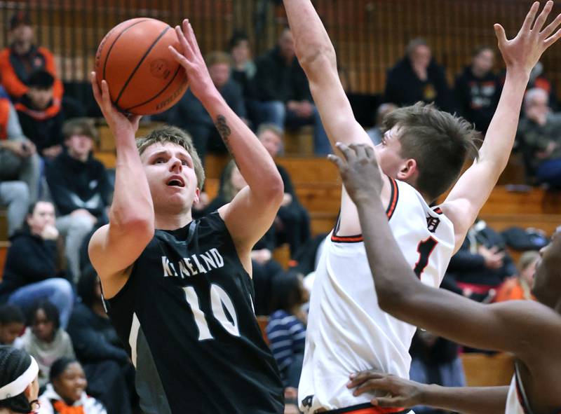 Kaneland's Troyer Carlson tries to shoot over DeKalb’s Jackson Kees during their game Monday, Feb. 12, 2024, at Huntley Middle School in DeKalb.