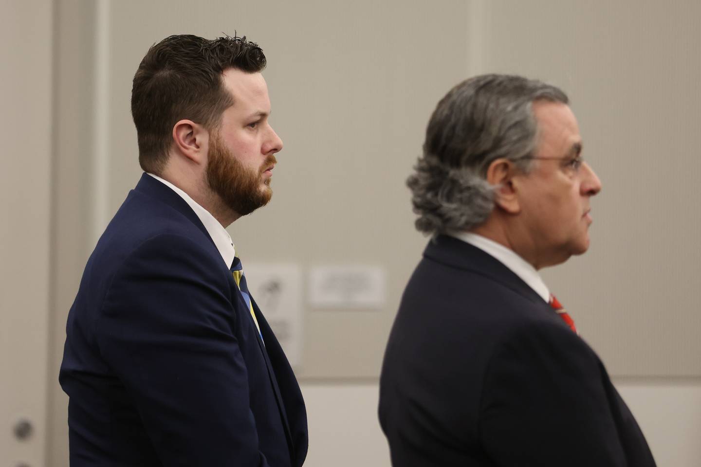 Sean Woulfe and Defense lawyer George Lenard stand as the jury enters the courtroom. Sean Woulfe, 29, is charge with reckless homicide of Lindsey Schmidt, 29, and her three sons, Owen, 6, Weston, 4, and Kaleb, 1. Monday, Mar. 28, 2022, in Joliet.