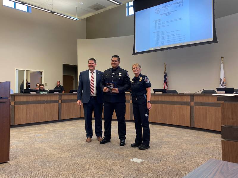 (Left to right) Mayor Christ Brown, Officer Caleb Mitchell and Police Chief Alicia Steffes. Mitchell was awarded with the Officer of the Year award on Monday night.