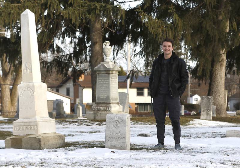 Mitchell Hopkins with veterans' headstones that he restored for an Eagle Scouts Project in the Crystal Lake Cemetery on Lake Avenue. The Crystal Lake Historic Preservation Commission has created a book, titled "Remembering Those Who Served,” documenting the lives of all 54 veterans since 1840 who are buried at the cemetery.