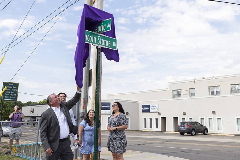 Mark Dallas unveils a sign in front of Dixon High School designating “Mark Dallas Way” on Tuesday, May 30, 2023.