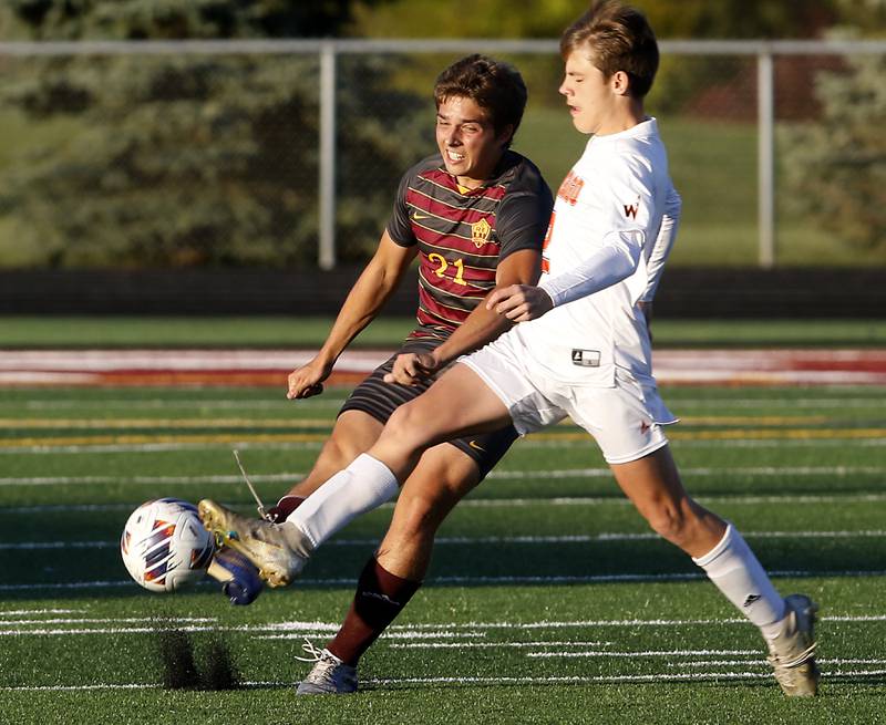 Richmond-Burton's Aidan Albert kicks the ball away from Winnebago's Ryan Melin during the IHSA Class 1A Richmond-Burton Regional Final soccer match Tuesday, Oct. 17, 2023, at Richmond-Burton High School in Richmond.