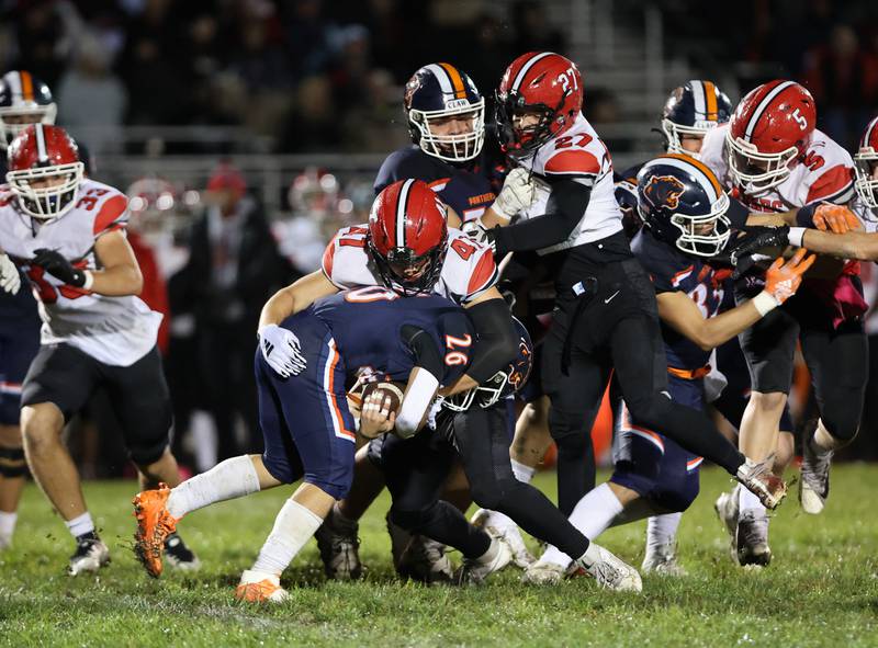 Oswego’s Noah Vera (26) is tackled by Yorkville’s Lincoln Reuterskiold (41) during the boys varsity football game on Friday, Oct. 6, 2023 in Oswego.