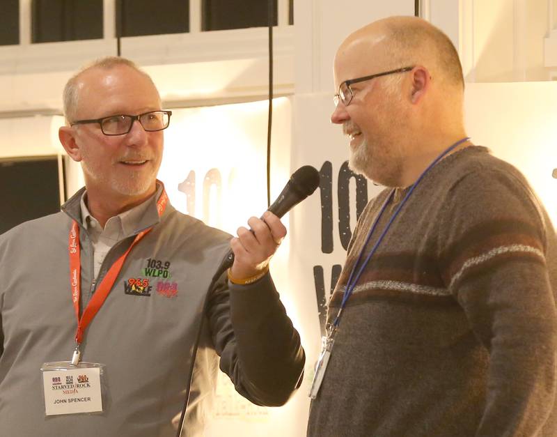 John Spencer, Starved Rock Media president interviews WLPO news director Jeremy Aitken on stage during the WLPO 75th Anniversary party on Wednesday, Nov. 16, 2022 at Senicas Oak Ridge in La Salle.