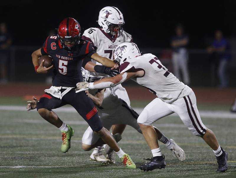 Huntley's Malik Carter tries to get out of the tackle attempt of Prairie Ridge's Ethan Hart during a Fox Valley Conference football game on Friday, Oct. 3, 2025, at Huntley High School.