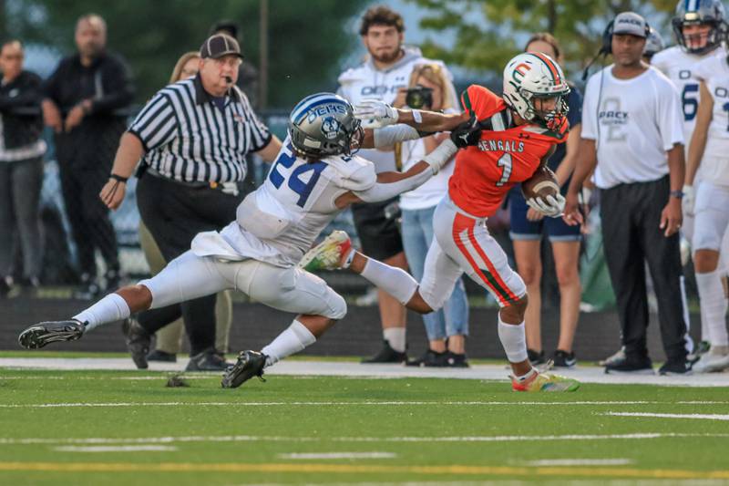 Plainfield East's Quinn Morris (1) fights off Oswego East's Junino Almeida (24) after a short reception during varsity football game between Oswego East at Plainfield East.  Sept 8, 2022