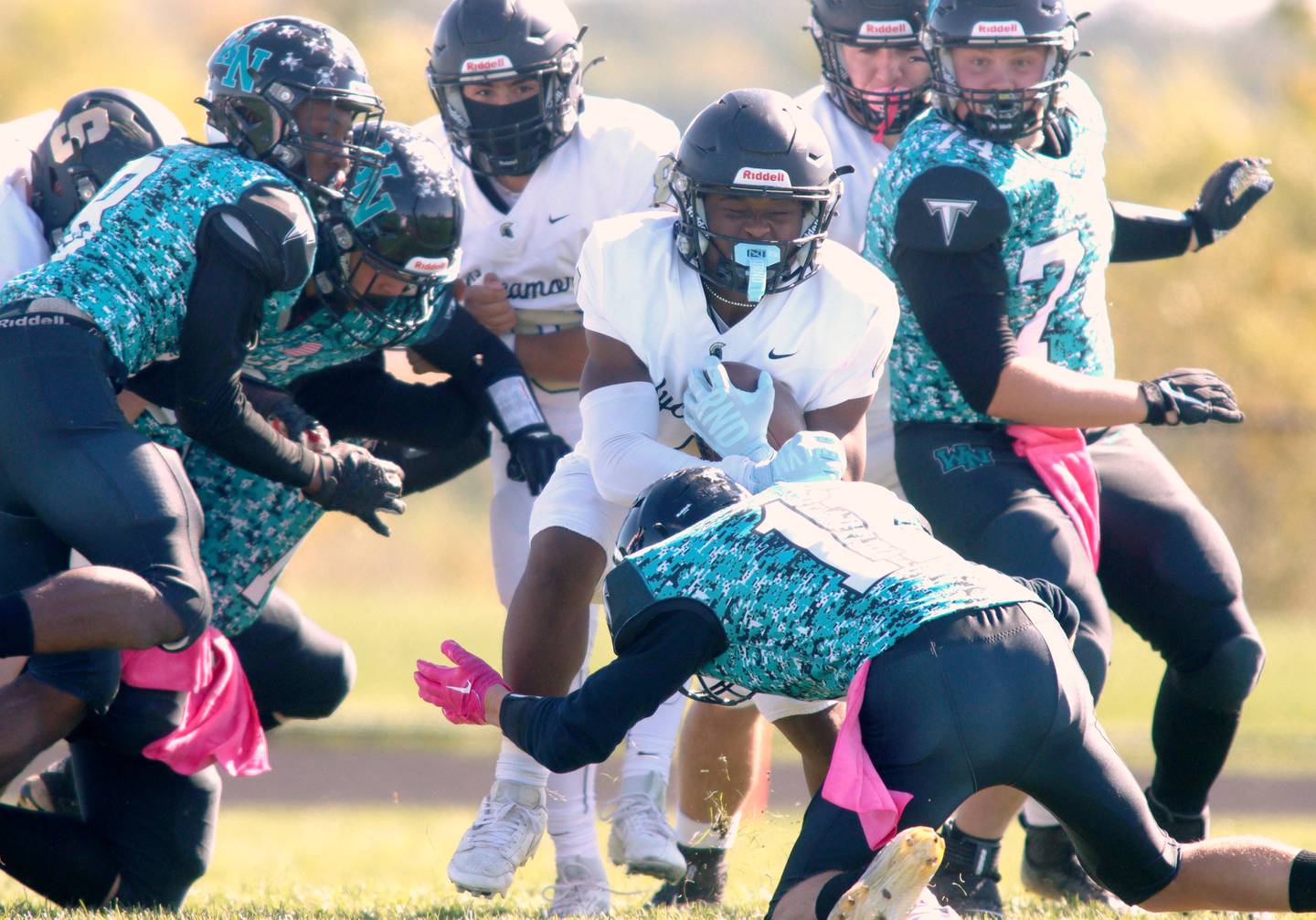 Sycamore’s Tyler Curtis runs the ball against Woodstock North in varsity football in Woodstock Saturday.