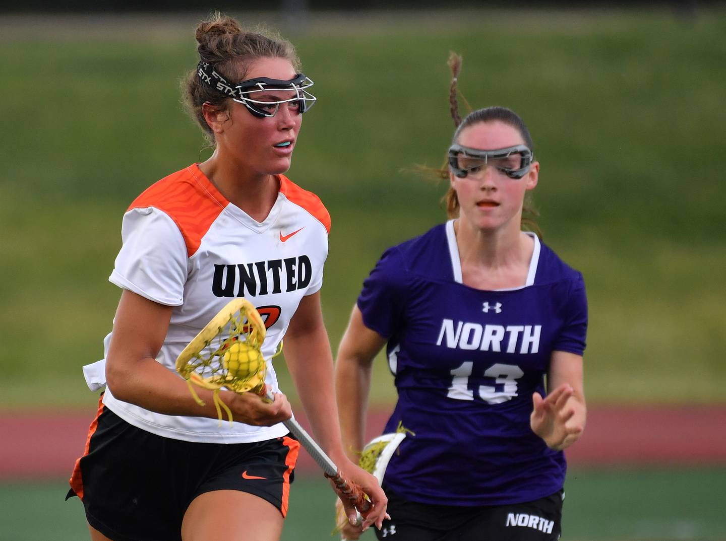 Crystal Lake’s Fiona Lemke races with the ball as Downers Grove North’s Finley Paul (13) chases during the Benet Supersectional game on June 3, 2025 at College of DuPage in Glen Ellyn.