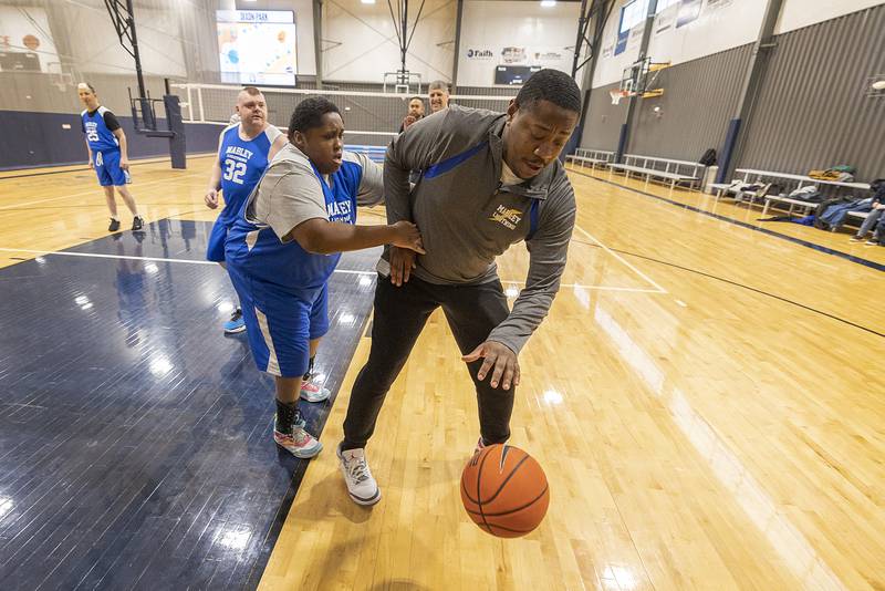 Coach Eli Townsend handles the ball during practice against Amea Wednesday, Dec. 18, 2024, in Dixon.