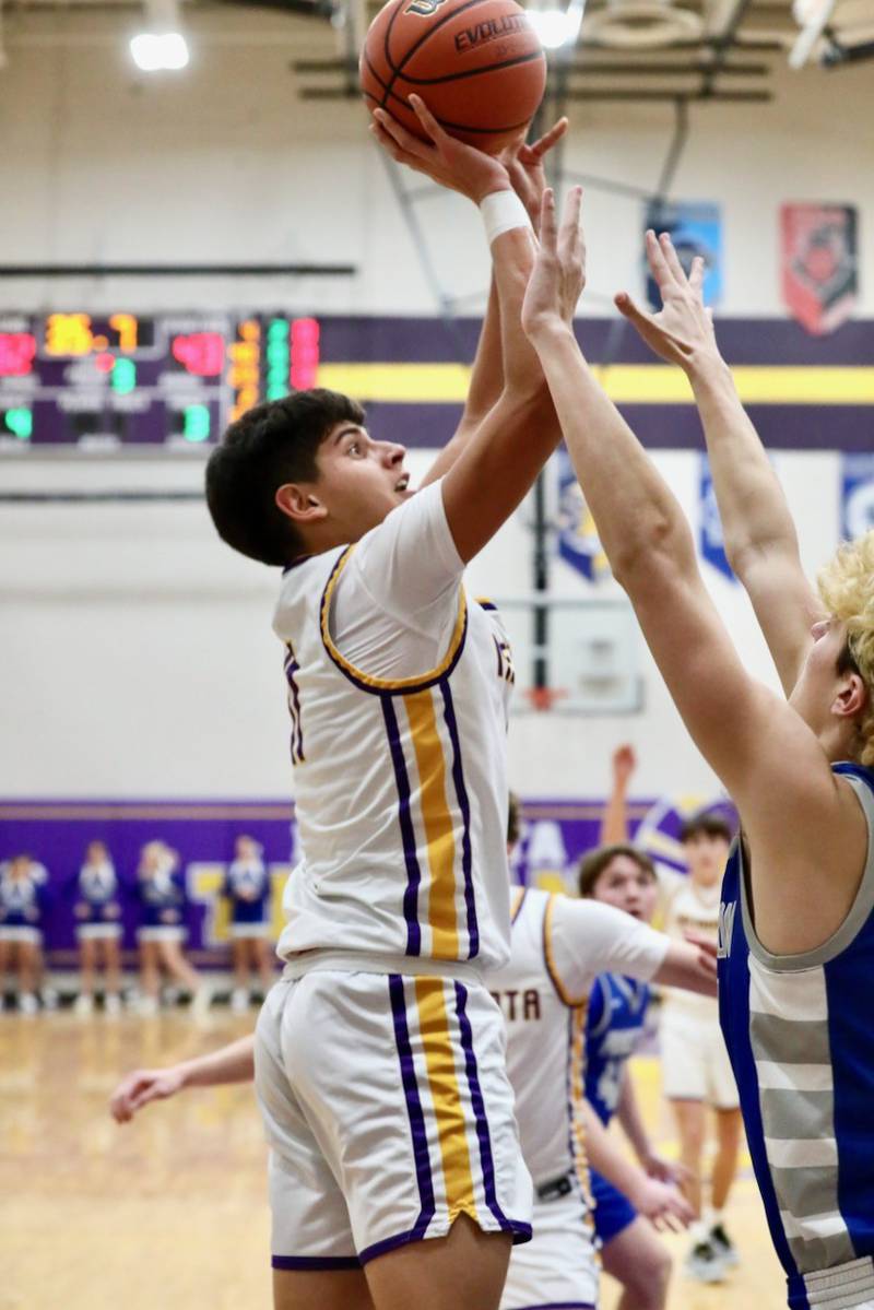 Mendota's Izaiah Nanez shoots over Princeton's Landon Roarke Friday night. The Tigers won 60-47.