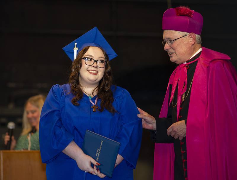 Meghan Simpson accepts her diploma from Bishop David Malloy Wednesday, May 18, 2022 during the 2022 commencement at Newman High School.