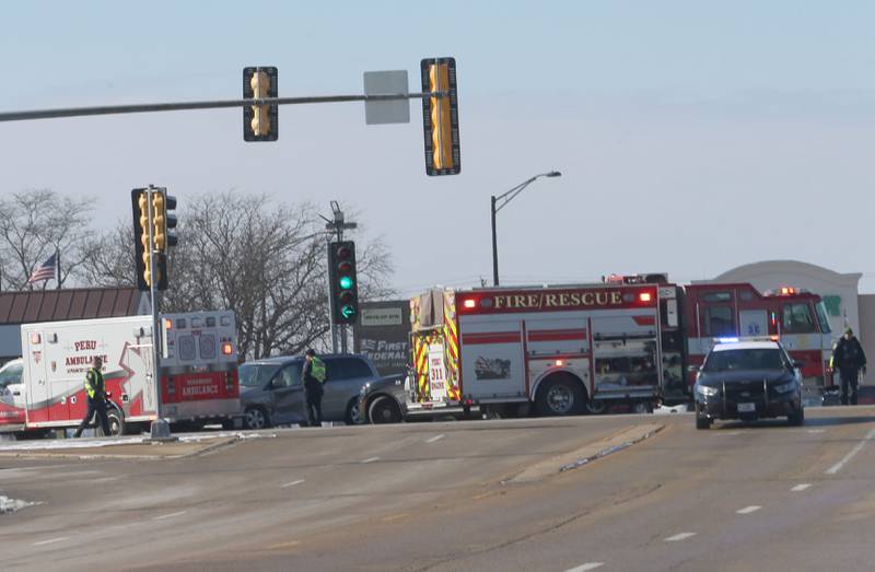 Peru Police, Fire and EMS work the scene of a two-vehicle crash at the intersection of Illinois Route 251and 38th Street in Peru. The crash happened shortly after noon.