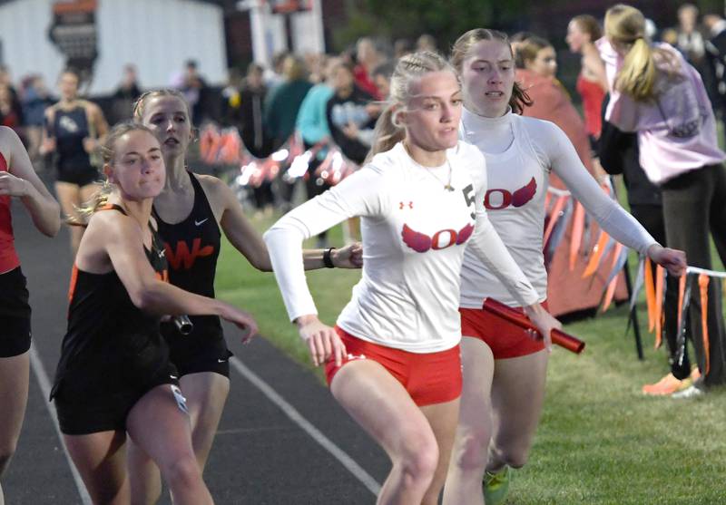 Oregon's Jillian Hammer (right) hands the baton off to Skylar Bishop on the final exchange of the 4x400 relay at the 1A Winnebago Sectional on Wednesday, May 13, 2026. The Hawks finished second in the race to Lena-Winslow.