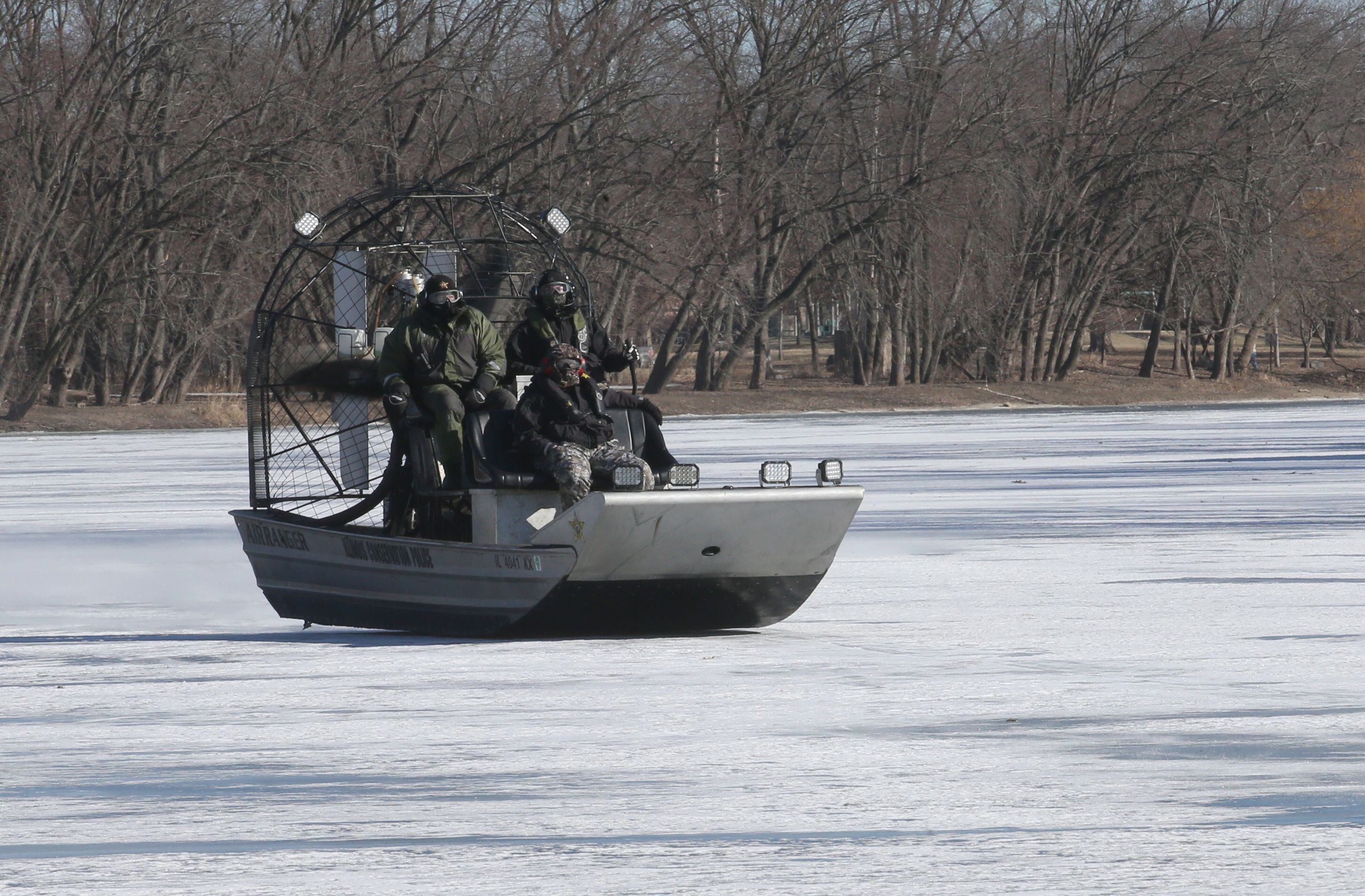 Illinois Department of Natural Resources Conservation Police officers use an airboat to glide on top of ice during a training mission on Monday, Jan. 27, 2025, along the Fox River in Ottawa.