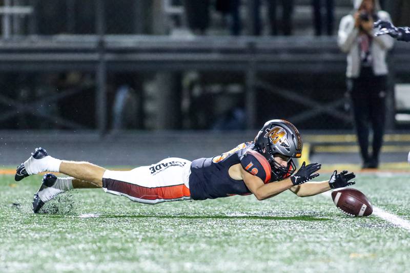 Minooka's Ty Couch (18) dives for a fumbled punt during football game between Plainfield North at Minooka.   Oct 6, 2023.