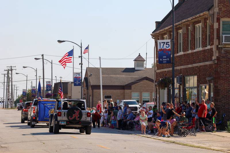 Children collect candy as attendees watch the Grand Pumpkin Parade during the St. Anne Pumpkin Festival on Saturday, Oct. 4, 2025.